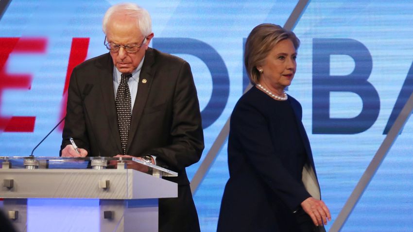 Democratic presidential candidate Senator Bernie Sanders (D-VT) and Democratic presidential candidate Hillary Clinton are seen on stage during a break in the broadcast of the Univision News and Washington Post Democratic Presidential Primary Debate at the Miami Dade College's Kendall Campus on March 9, 2016 in Miami, Florida.