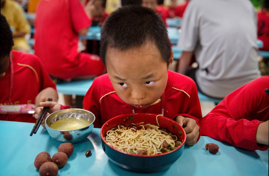 A young player eats in the school's canteen. Special chefs have been flown in from the northwestern Xinjiang province to cater for the dietary requirements of the region's Muslim players.