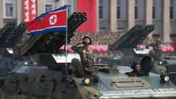 A North Korean soldier salutes from a tank during a military parade past Kim Il-Sung square marking the 60th anniversary of the Korean war armistice in Pyongyang on July 27, 2013.  North Korea mounted its largest ever military parade on July 27 to mark the 60th anniversary of the armistice that ended fighting in the Korean War, displaying its long-range missiles at a ceremony presided over by leader Kim Jong-Un.  AFP PHOTO / Ed Jones        (Photo credit should read Ed Jones/AFP/Getty Images)