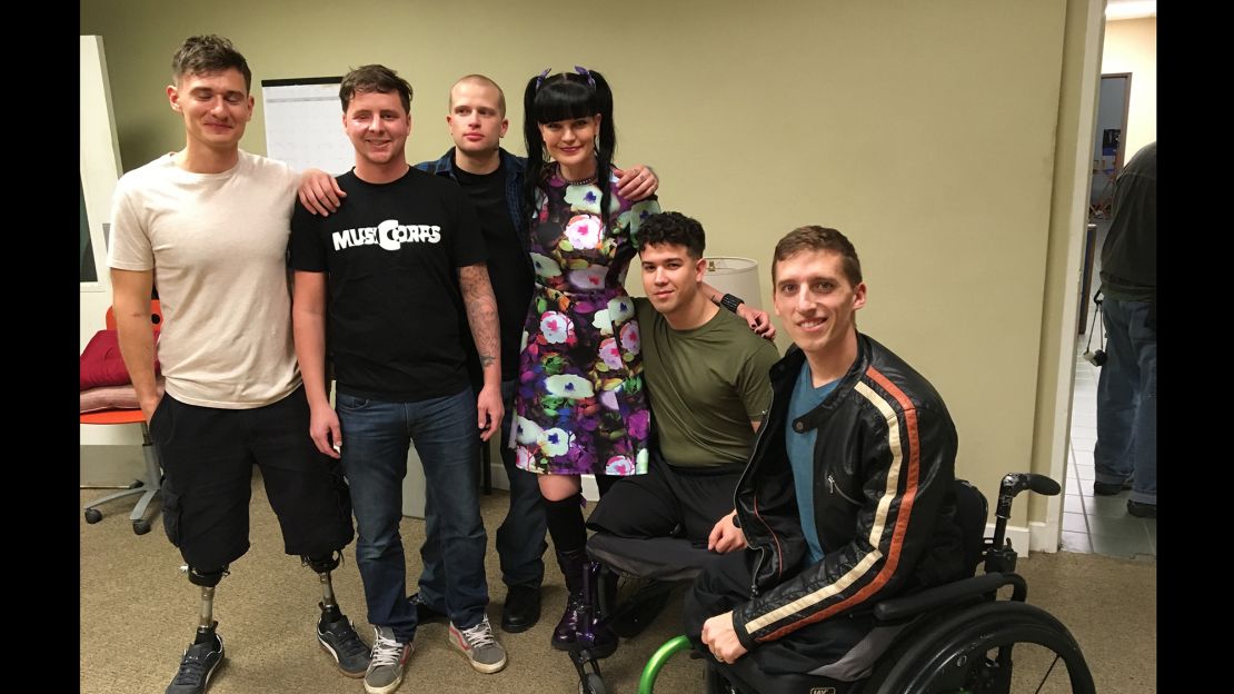 "NCIS" cast member Pauley Perrette, center, poses with the MusiCorps members.