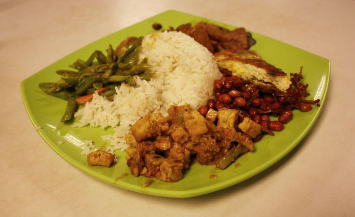 Nasi padang, a Malay dish, here is comprised of steamed rice, vegetables,   peanuts, anchovies, tofu, beef, and potato patties.