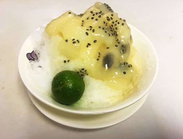 Soursop fruit is served with lime on a bed of crushed ice.