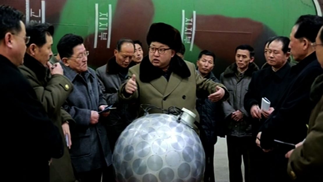 This undated picture released from North Korea's official Korean Central News Agency (KCNA) on March 9, 2016, shows North Korean leader Kim Jong Un in front of a device analysts have dubbed the "disco ball."