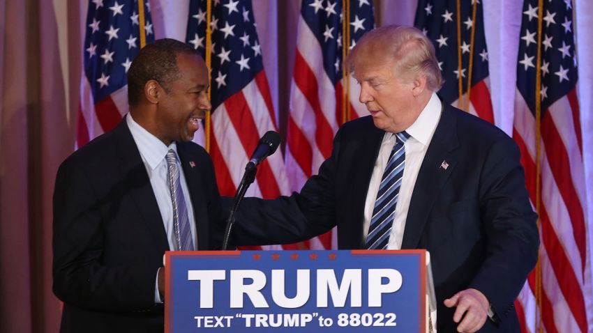 Republican presidential candidate Donald Trump stands with former presidential candidate Ben Carson as he receives his endorsement at the Mar-A-Lago Club in Palm Beach, Florida on March 11.