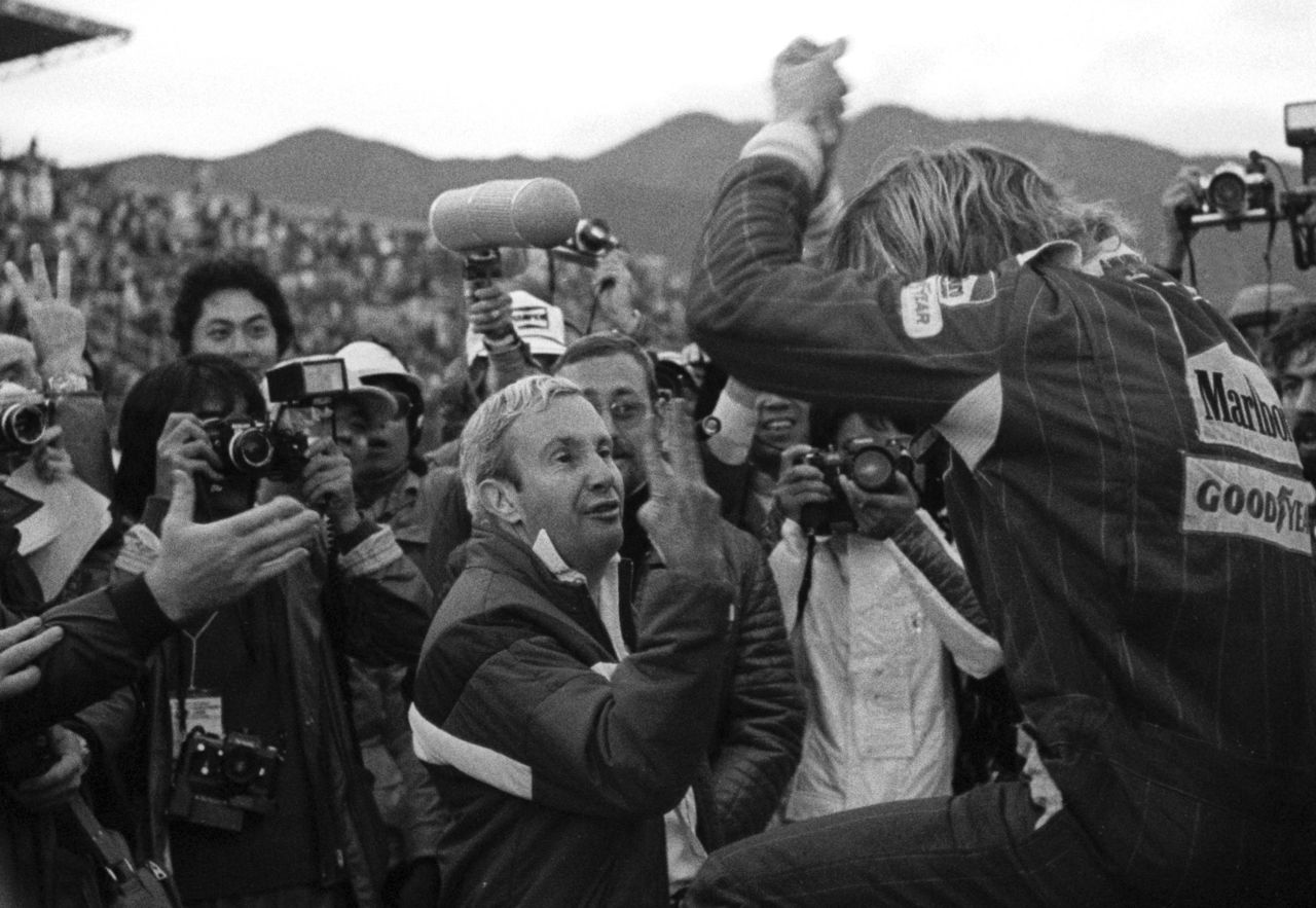 Hunt clinched his one and only F1 drivers' championship in the final race of the season -- the Japanese Grand Prix in Fuji. Here, McLaren team manager Teddy Mayer holds up three fingers to Hunt (right), who is climbing out of his car after the race, to signal he had finished third and clinched the 1976 title.