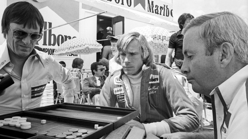 (L to R): Bernie Ecclestone (GBR) Brabham Team Owner plays backgammon in the paddock with James Hunt (GBR) McLaren, who retired from the race on  lap 11 with a blown engine, and Teddy Mayer (USA) McLaren Team Owner.
Formula One World Championship, Rd5, Spanish Grand Prix, Jarama, Spain, 8 May 1977.