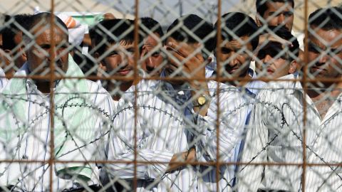 Detainees stand in the Abu Ghraib prison yard while waiting to be released on June 27, 2006, in Baghdad, Iraq.