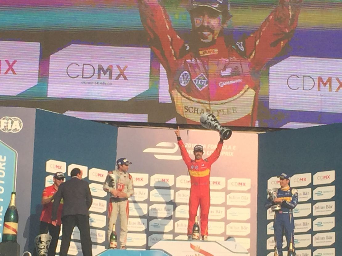 Lucas di Grassi (center) celebrates on the podium following Formula E's first ever race in Mexico.