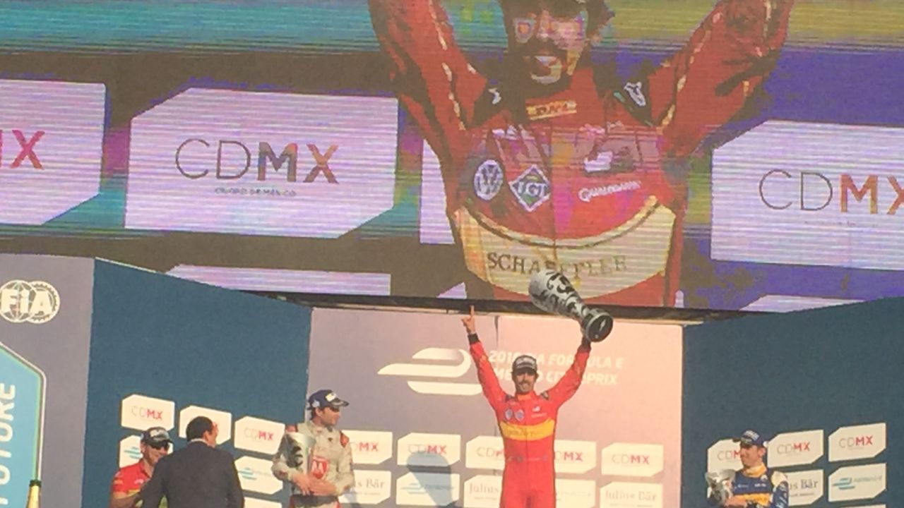 Lucas di Grassi (center) celebrates on the podium following Formula E's first ever race in Mexico.