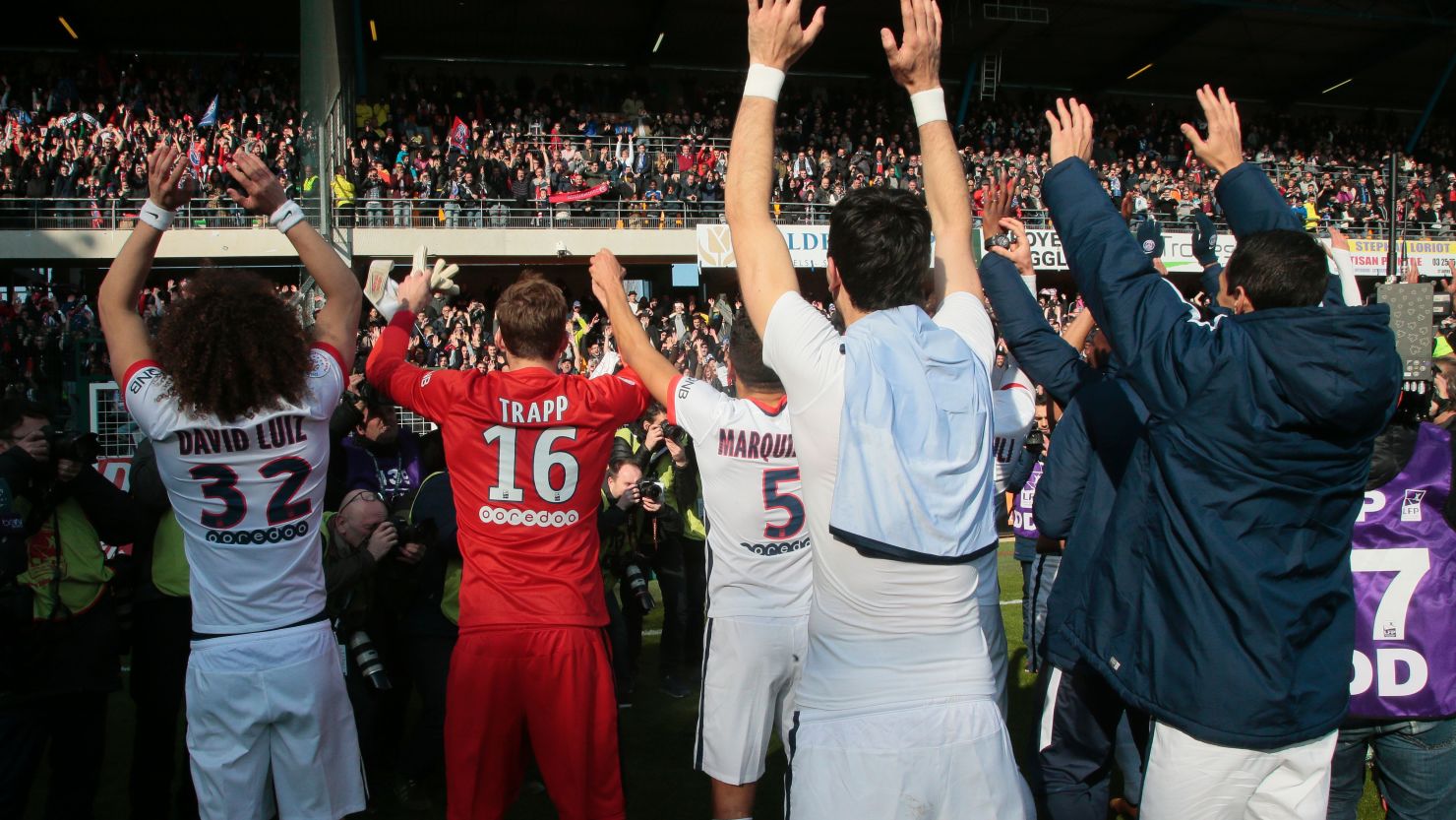 Paris Saint-Germain's team celebrates with its supporters after clinching its fourth straight Ligue 1 title and sixth overall.