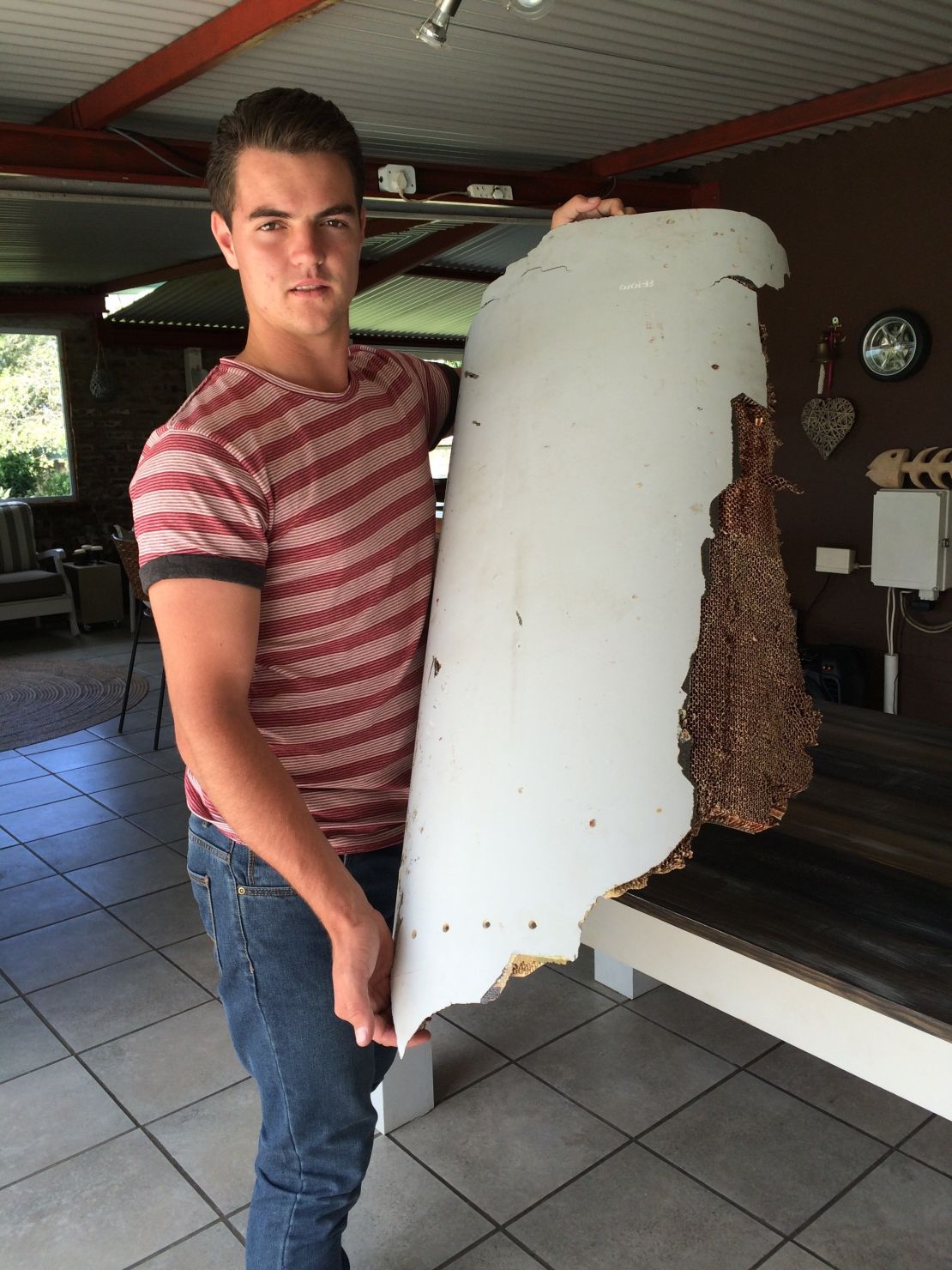 South African teen Liam Lotter holding the debris he found on a Mozambique beach.