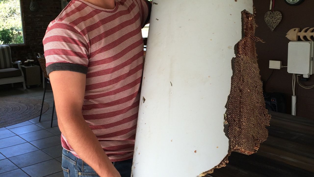 South African teen Liam Lotter holding the debris he found on a Mozambique beach.