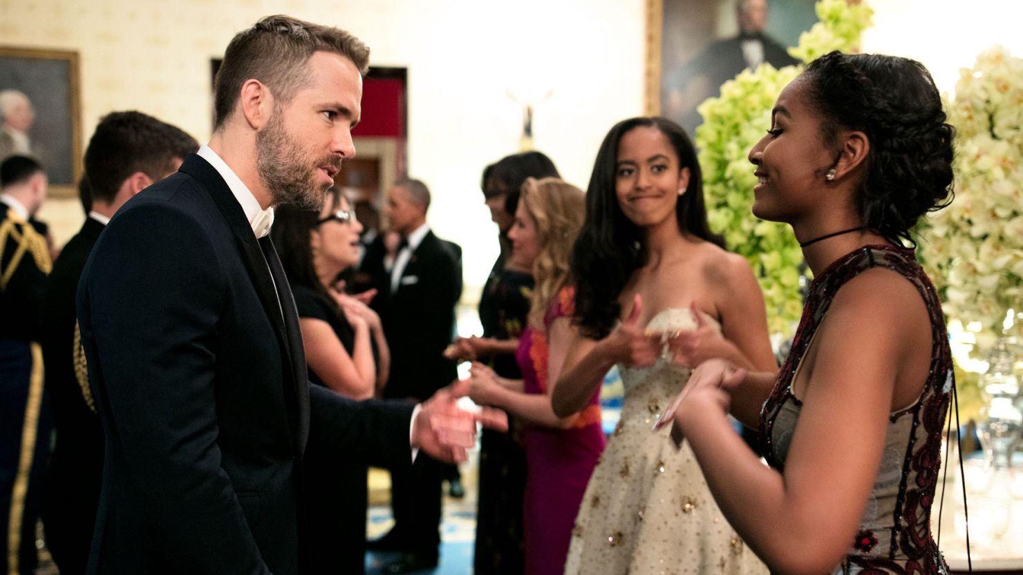 Malia Obama offered some sisterly support as Sasha Obama talked to "Dead Pool" star Ryan Reynolds. 