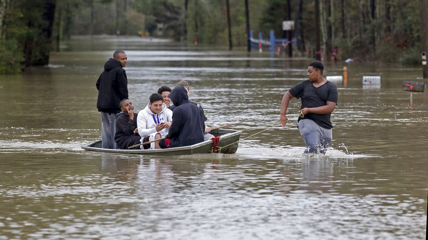Zavion Watson pulls a boat full of relatives to dry land on March 11 as they evacuate their homes in Independence, Louisiana. Heavy rain has brought flooding that damaged thousands of homes.