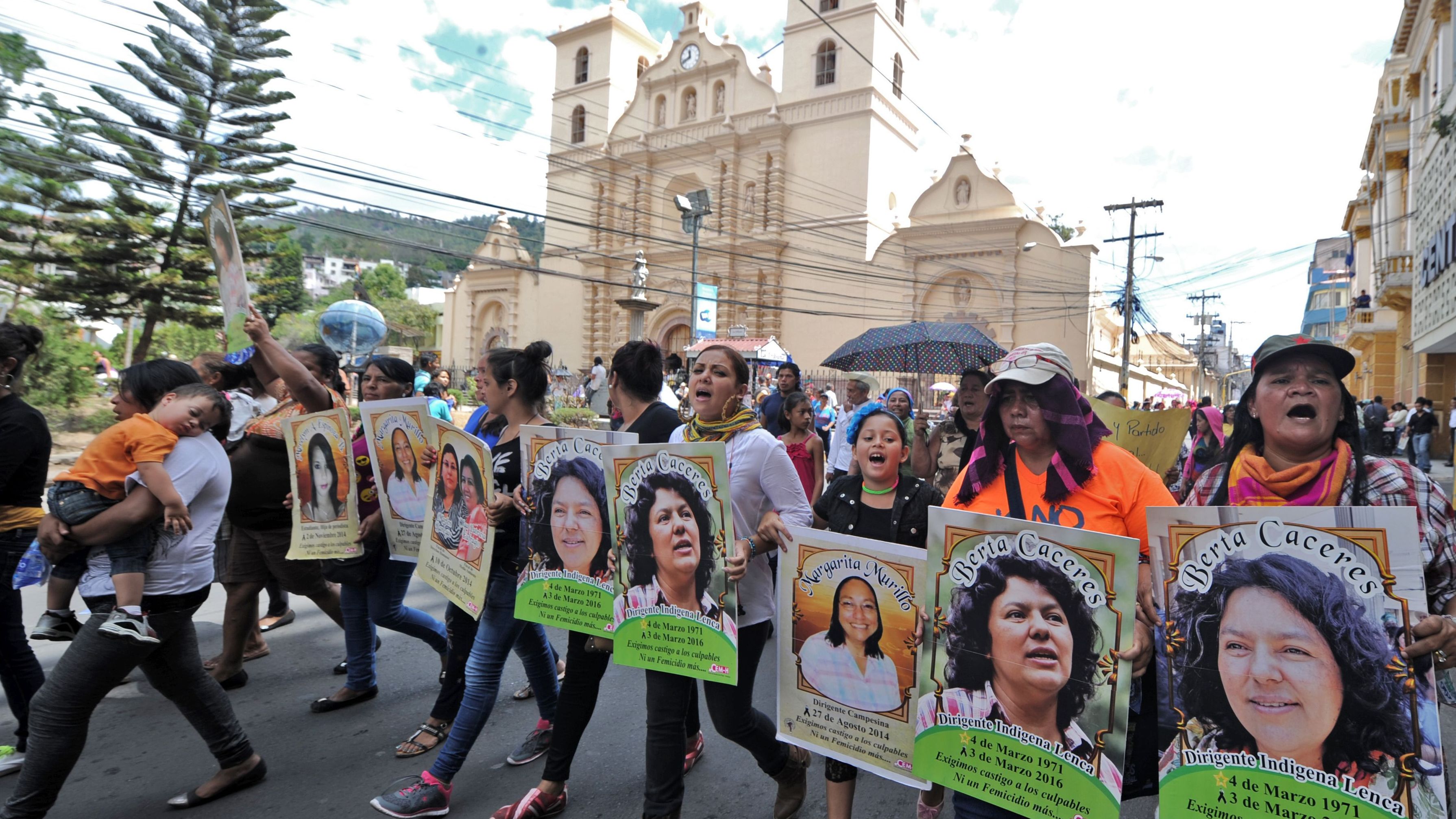 Protesters hold pictures of Berta Caceres at an International Women's day demonstration in Tegucigalpa on March 8.