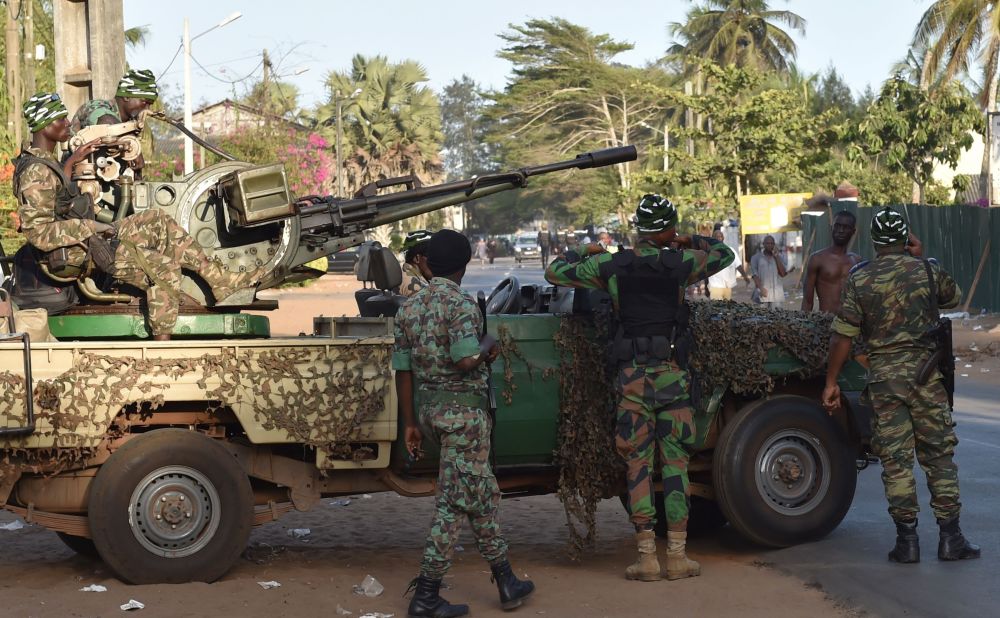 Ivory Coast's armed forces take position outside one of the hotels.