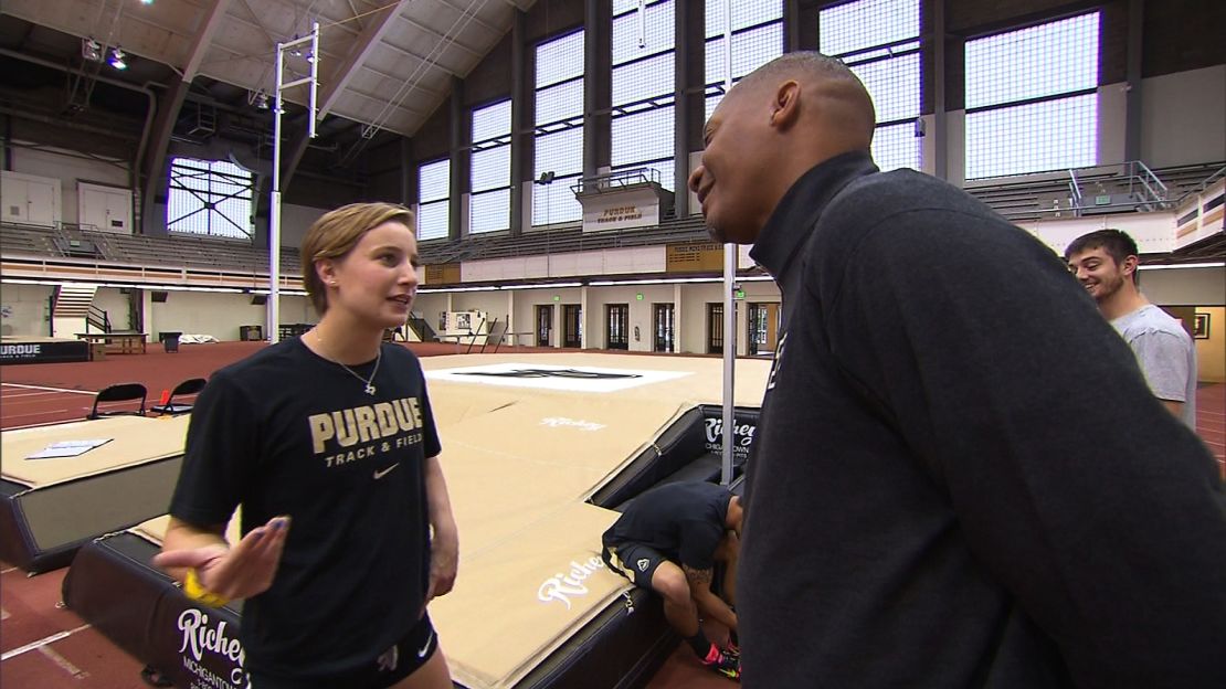 Purdue University assistant track and field coach Chris Huffins discusses strategy with Brown.