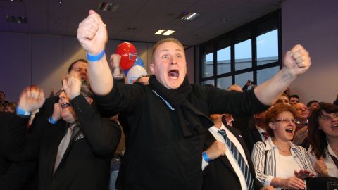 Alternative for Germany (AfD) supporters react after exit poll results are announced on March 13, 2016.