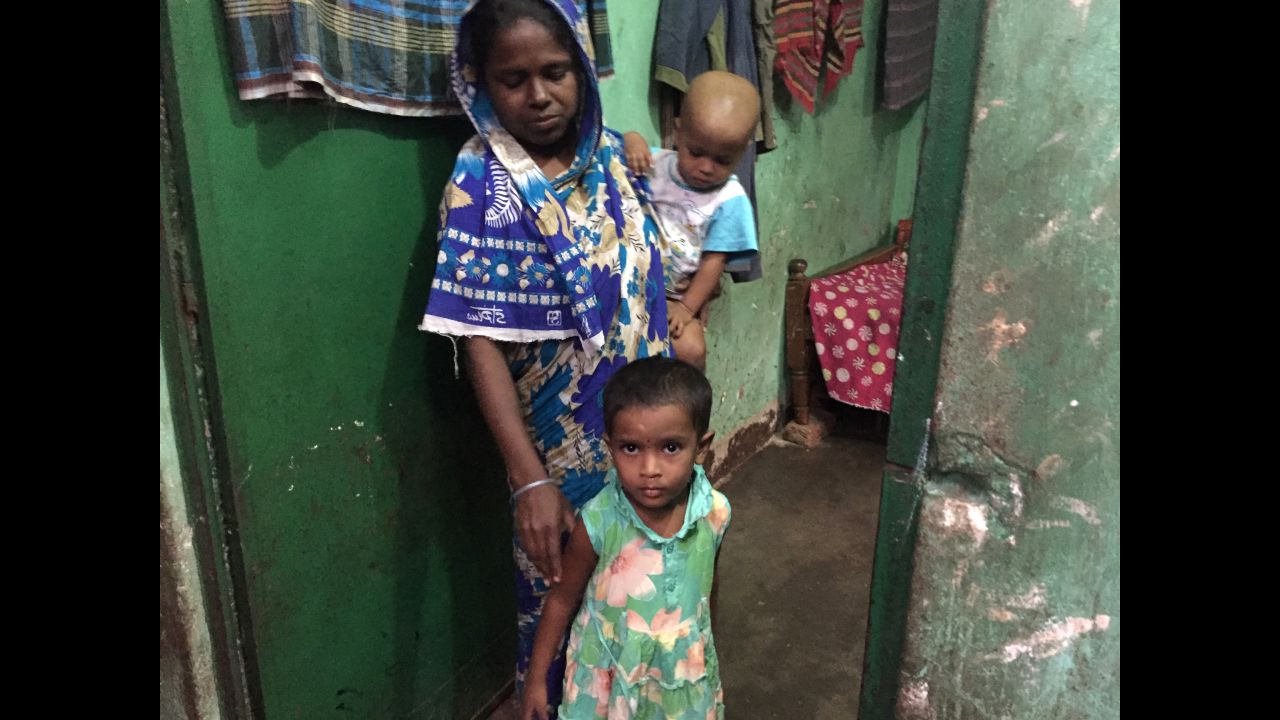 Munni, center, takes a break from playing outside to greet a group of researchers visiting her mother, Banu. Researchers have been stopping by the family's home for years to find out if Munni, who received the rotavirus vaccine as a baby, has been ill. 