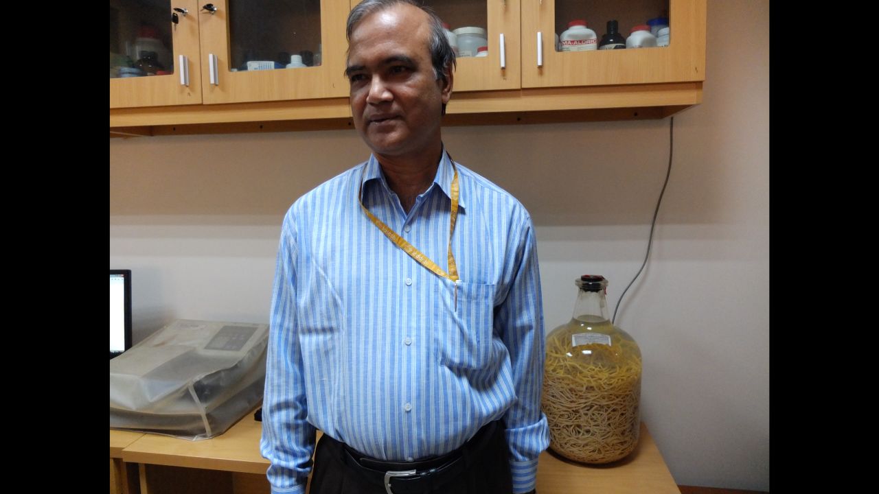 Dr. Rashidul Haque keeps a jar of worms in his office as a reminder of public health progress.