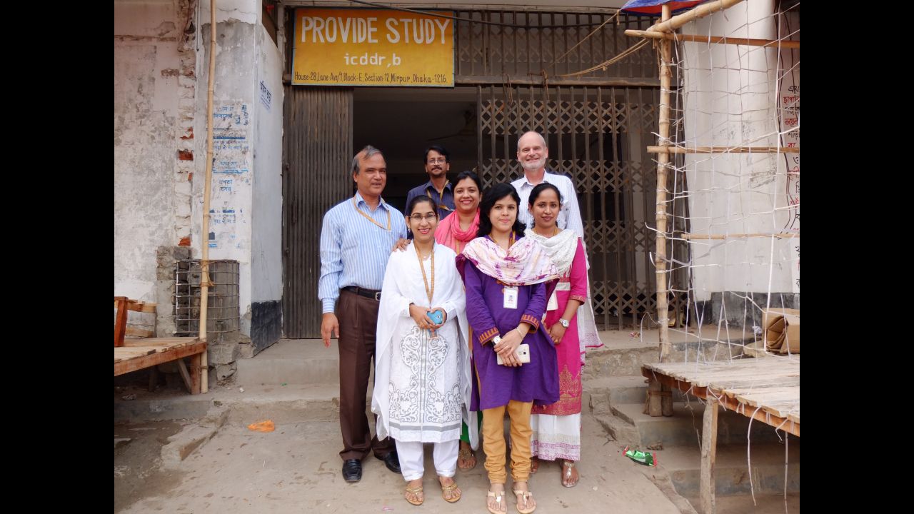 Dr. Rashidul Haque, left, and Dr. William Petri, rear right, and their colleagues stand at the entrance to the clinic where they are investigating why the rotavirus vaccine does not work as well in Bangladesh as it does in high-income countries. They're looking for ways to improve its performance.
