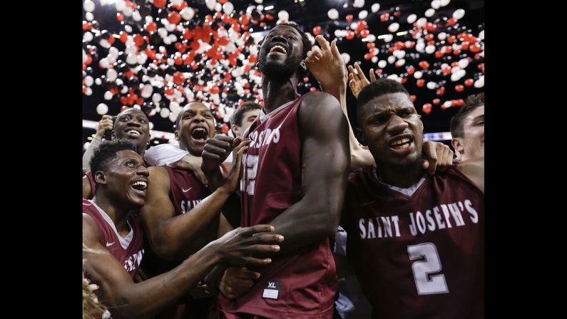 Saint Joseph's players celebrate after beating VCU in the championship NCAA basketball game of the Atlantic 10 men's tournament on Sunday, March 13, in New York. <br />
