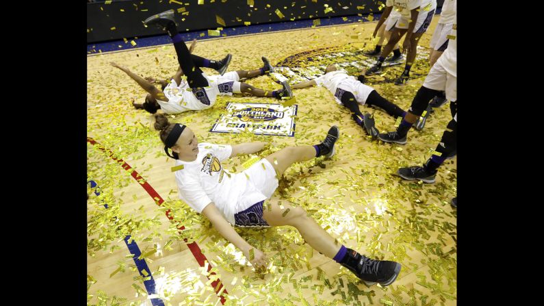 Central Arkansas' Maggie Proffitt plays in confetti on the floor with teammates while celebrating a win over Sam Houston State in an NCAA college basketball game in the championship of the Southland Conference Tournament, on Sunday, March 13, in Katy, Texas.