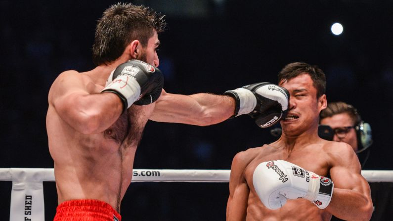 Marat Grigorian, left, punches Sitsongpeenong during the Kickboxing World Championship on Saturday, March 12, in Paris. 