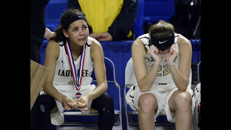 Upperman's Akira Levy, left, and Ashlyn Medley, right, cry after their loss against East Nashville in the Tennessee high school basketball championship game Saturday, March 12, in Murfreesboro, Tennessee. 