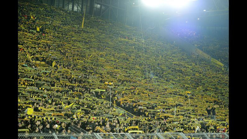 The Borussia fans on the southern tribune sing "you will never walk alone" after a supporter died of a heart attack during the German Bundesliga soccer match between Borussia Dortmund and FSV Mainz 05 in Dortmund, Germany, on Sunday, March 13. 