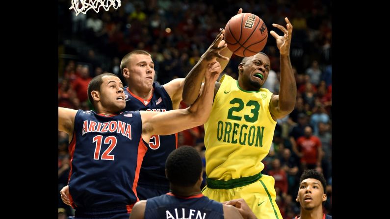 Elgin Cook, no. 23, of the Oregon Ducks goes up for a rebound against Ryan Anderson, no. 12, of the Arizona Wildcats during a semifinal game of the Pac-12 Basketball Tournament on Friday, March 11, in Las Vegas.<br />