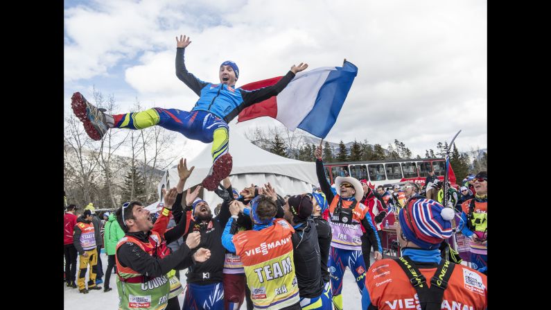 Maurice Manificat celebrates with the France team after Cross Country Men 15.0 km Pursuit Classic on Saturday, March 12, in Canmore, Alberta, Canada. 