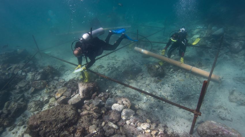 Divers excavate a wreck site off the coast of Oman