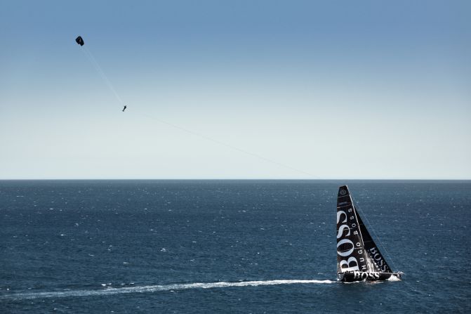 Using the boat's speed to propel himself, the British around-the-world sailor soars 280 feet into the air above the yacht.