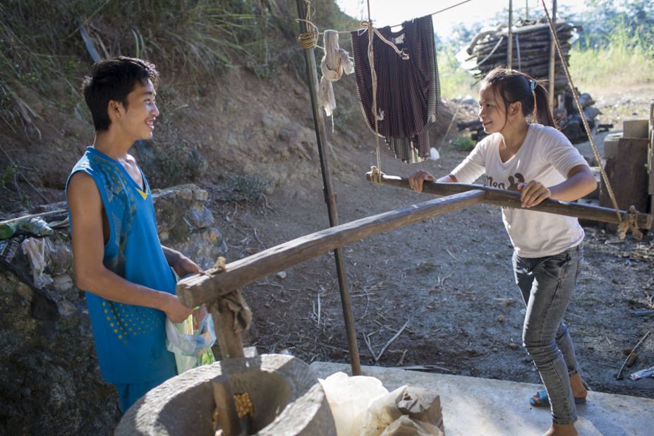 Cai and her husband Ming use a neighbor's hand mill to grind corn. Ming says he misses his single life because he could hang out a lot with his friends before, but now his friends won't take him out because they are afraid that Cai will disapprove.