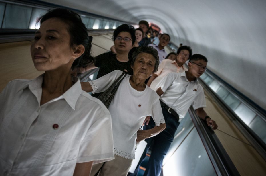 North Koreans head down to the Pyongyang Metro. It's 100 meters underground thus riding the escalator down to the station takes a couple of minutes. 