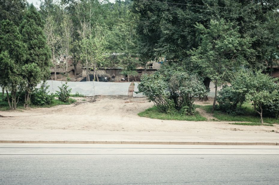 These settlements, captured from a speeding van, appear to be slums outside of Pyongyang, according to Huniewicz. He speculates that the tourist transport vans slow down when passing what the authorities are proud of showing and speed past less desirable sights. 