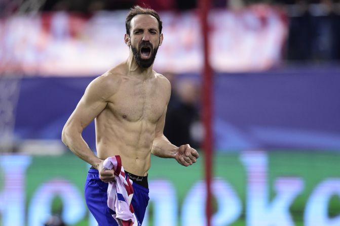 Veteran Atletico Madrid defender Juanfran rips his shirt off in celebration after scoring the decisive penalty in the shootout to knock out PSV. 
