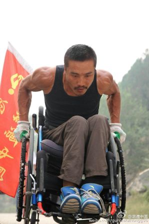 Quan Peng says he doesn't like to ask for help and has wheeled himself all the way -- as his bulging arm muscles prove.