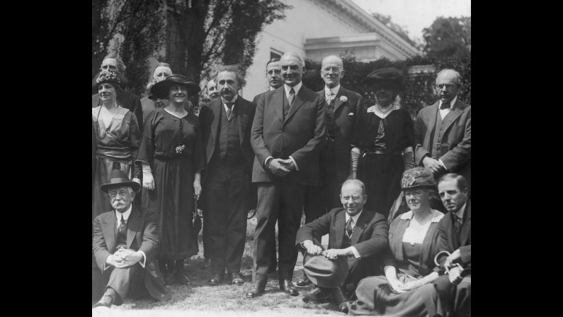 Einstein stands with his wife, Elsa, as they visit the White House in 1921. Standing in front of Einstein is U.S. President Warren G. Harding.
