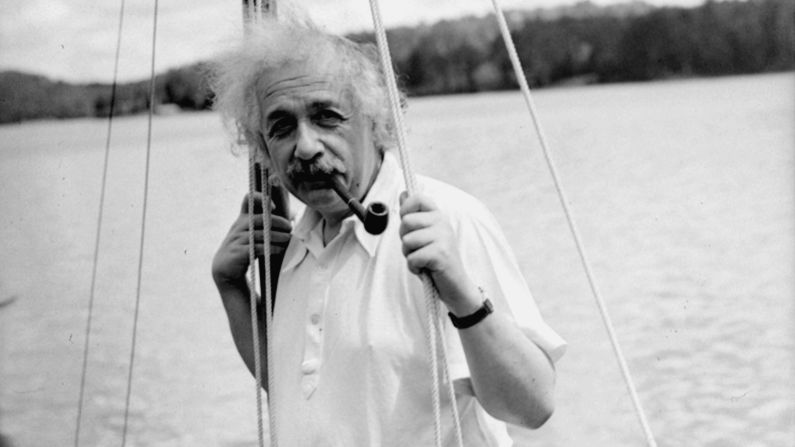 Einstein leans against the mast of a sailboat in Saranac Lake, New York, in 1936.