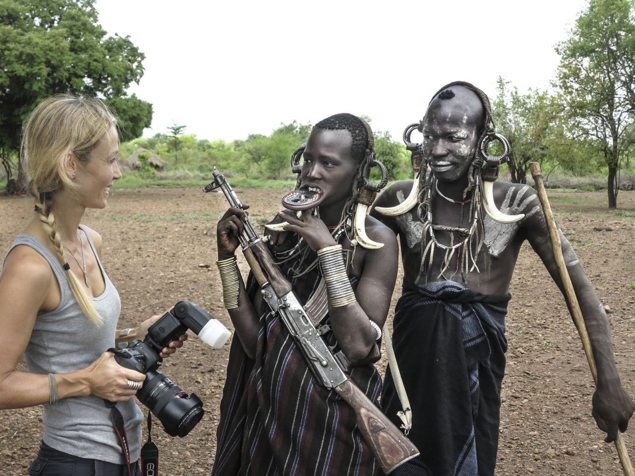 Seton has discussions with the Mursi tribe while taking photographs in their village.