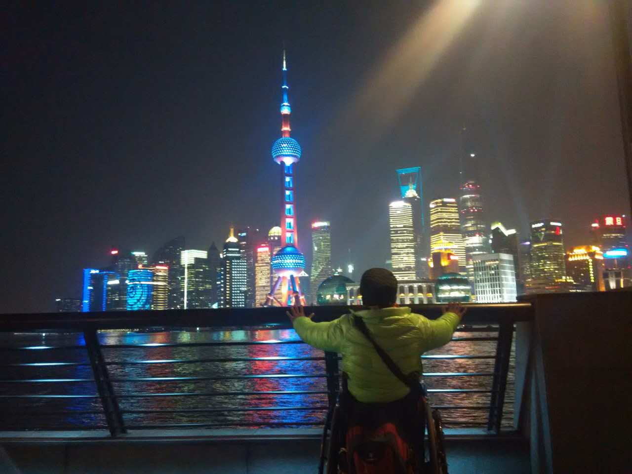Quan Peng gazes at Shanghai's Pudong financial district across the Huangpu River.