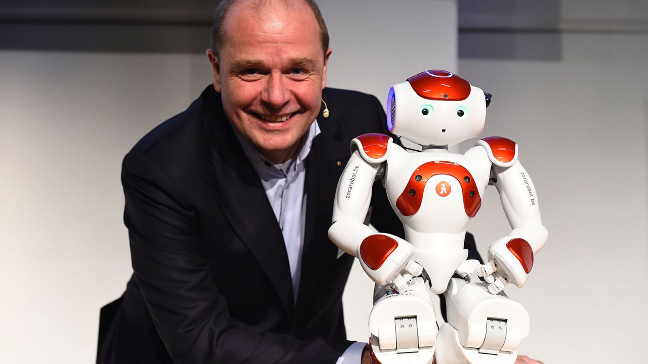 Pictured here with one of his developers, Fabrice Goffin of Belgium's Zora Robotics, Mario is a small robot who began life as a health worker but is now being used in hotels.