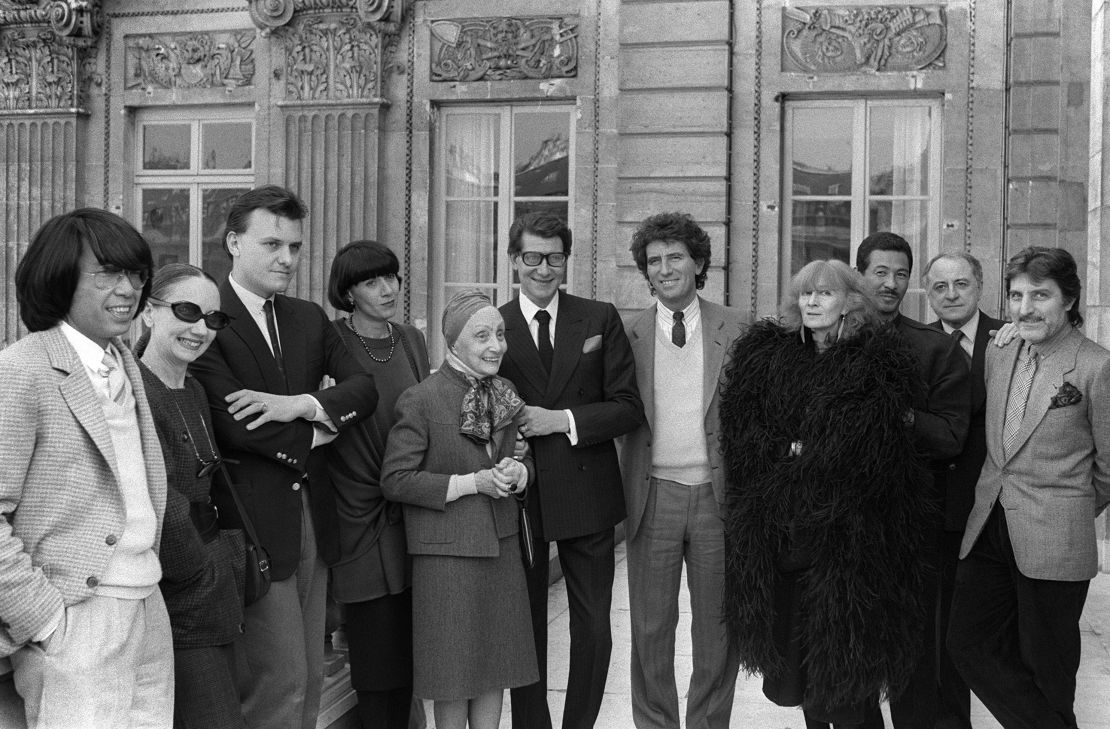 Sonia Rykiel (in black feathers) poses with the French Minister of Culture Jack Lang (7th L) and her fashion contemporaries fashion in Paris in 1984. 