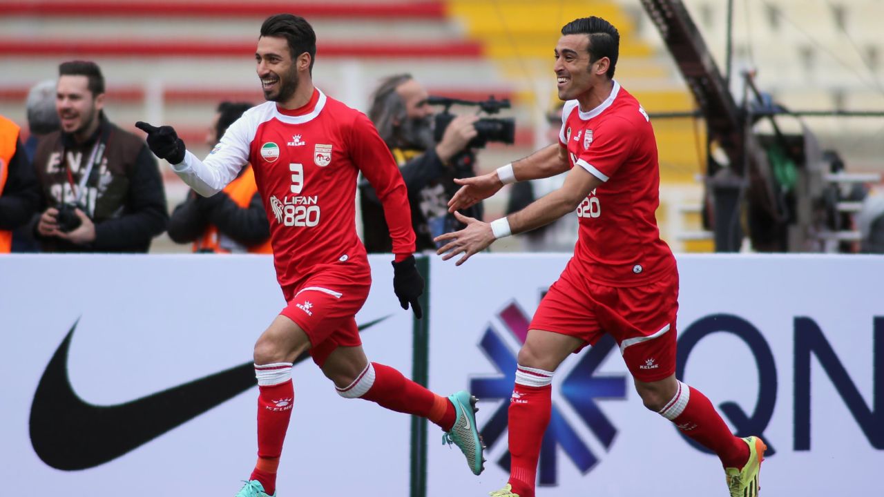 Tractorsazi's Shoja Khalilzadeh (L) celebrates with his teammate Bakhtiar Rahmani after scoring a goal during their AFC Champions League match against UAE's al-Jazira in Tabriz in February 2016.
