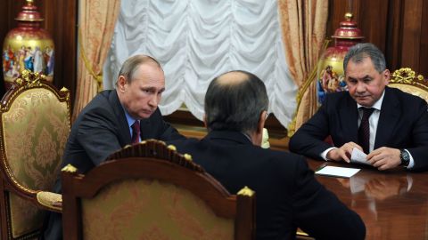 Russian President Vladimir Putin meets with Defense Minister Sergey Shoigu, right, and Foreign Minister Sergey Lavrov, center, at the Kremlin in Moscow on Monday.