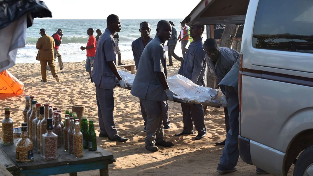 A body is loaded into a van after the attack.