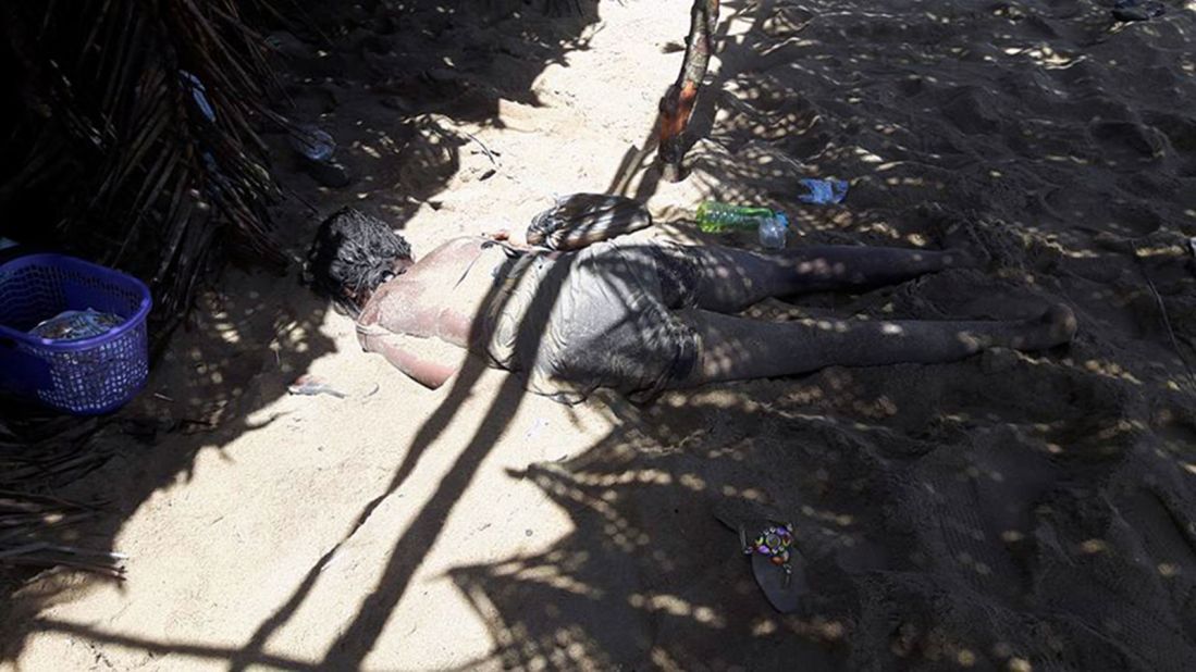 A photo taken by a witness to the attack shows a woman's body on the beach.