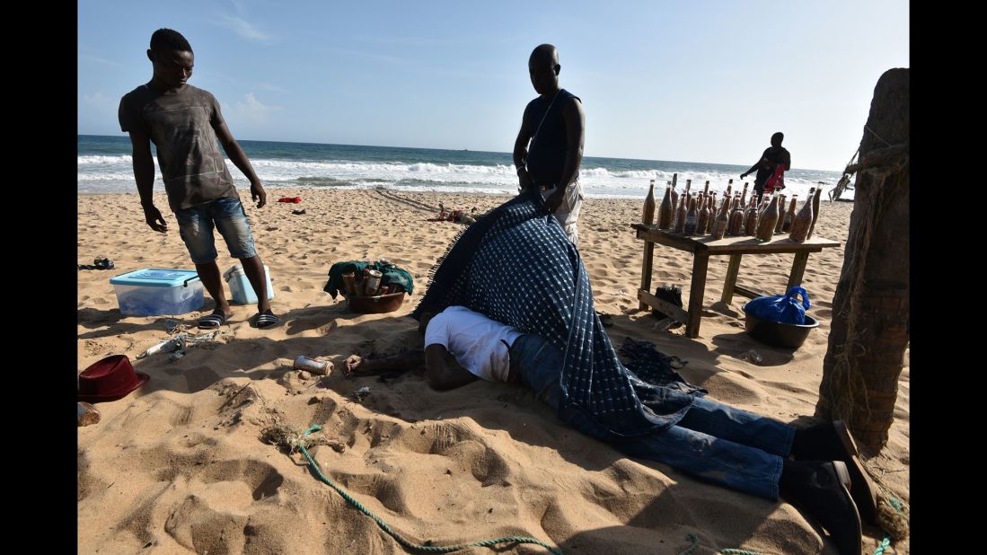 A man covers the body of a victim.